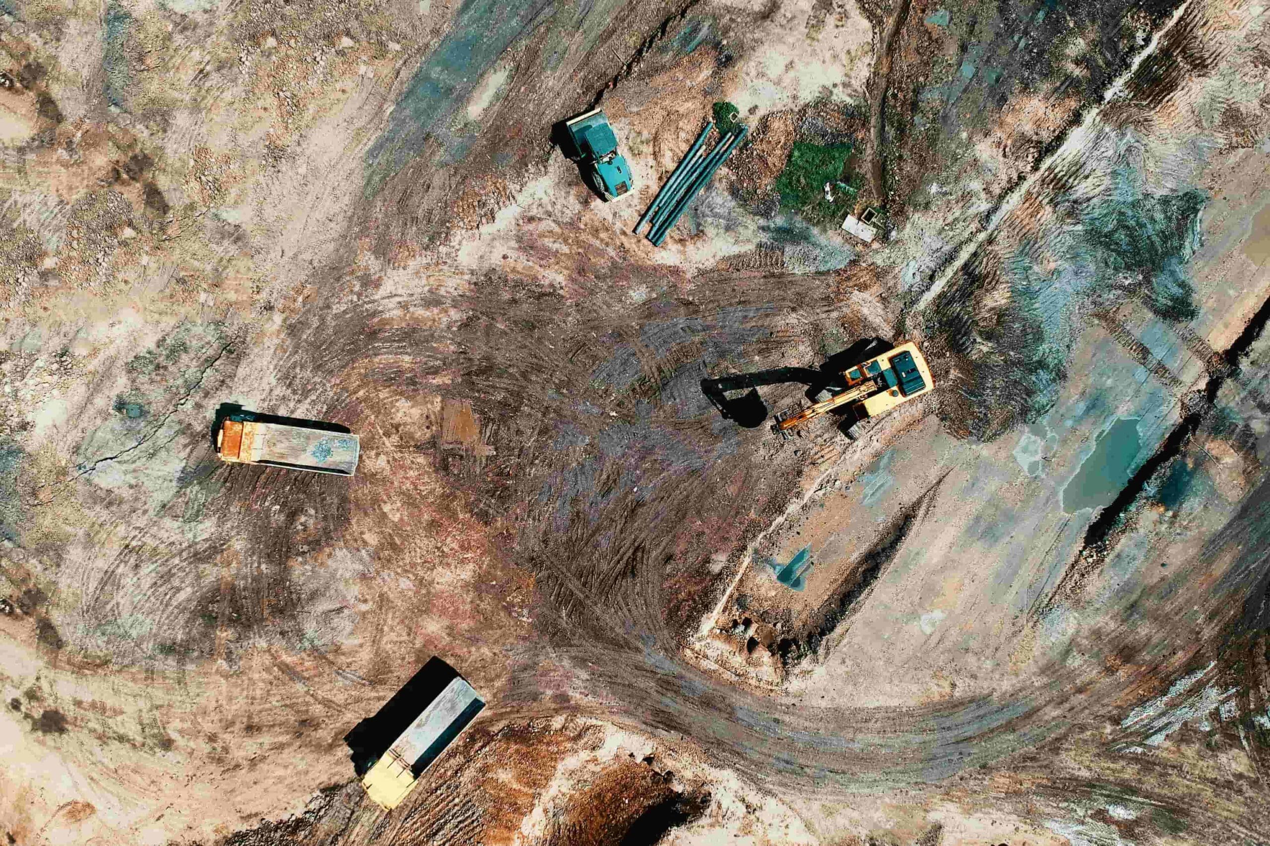 industrial construction site trucks scattered throughout the site